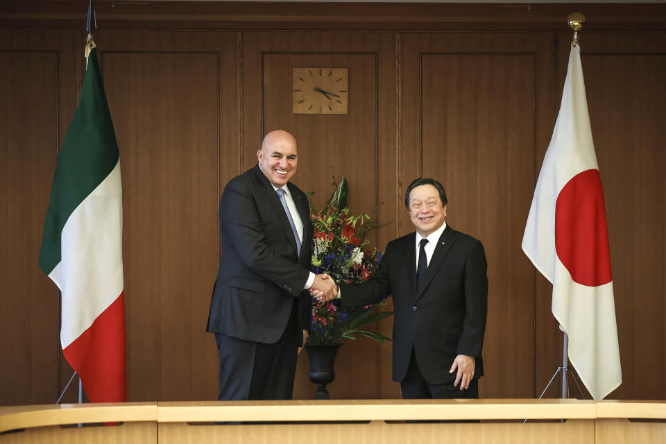 Italy's Defense Minister Guido Crosetto, left, shakes hands with Japan's Defense Minister Yasukazu Hamada during a bilateral meeting Thursday, March 16, 2023 in Tokyo, Japan. (Takashi Aoyama/Pool Photo via AP)