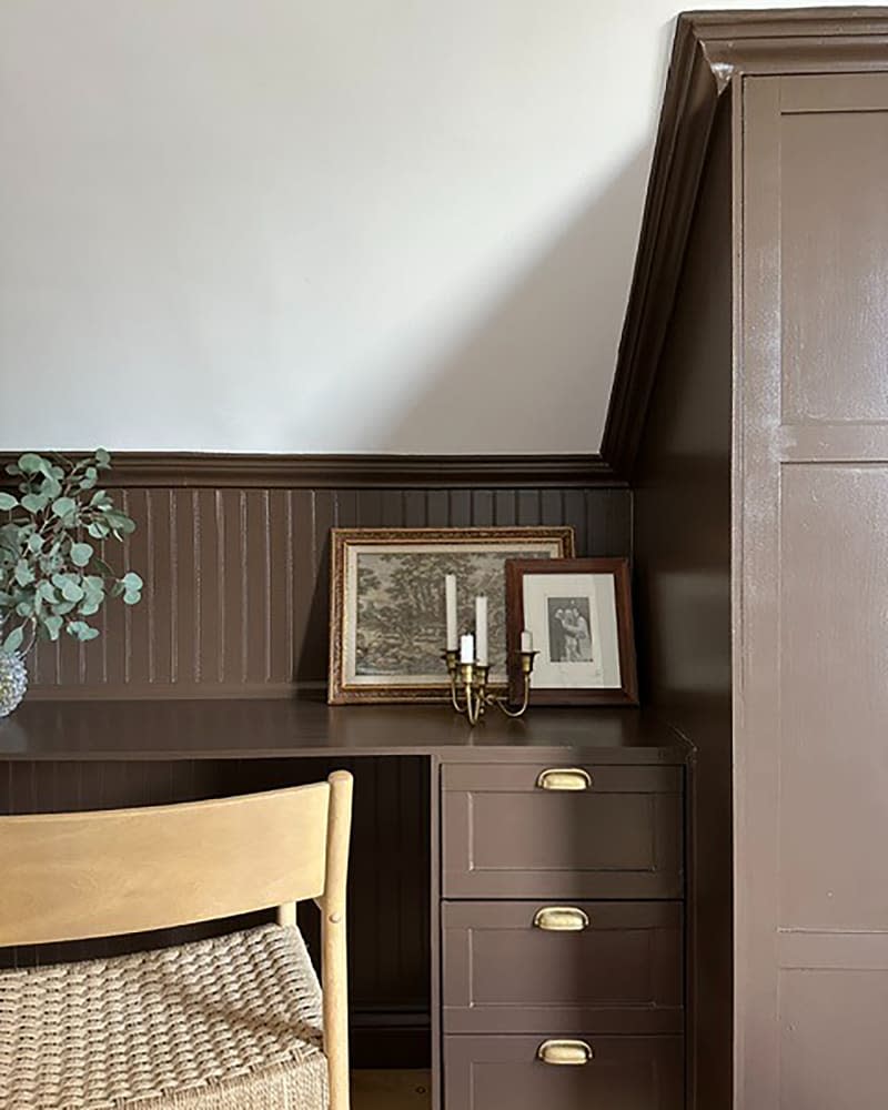 Brown painted desk in hallway of newly renovated home.