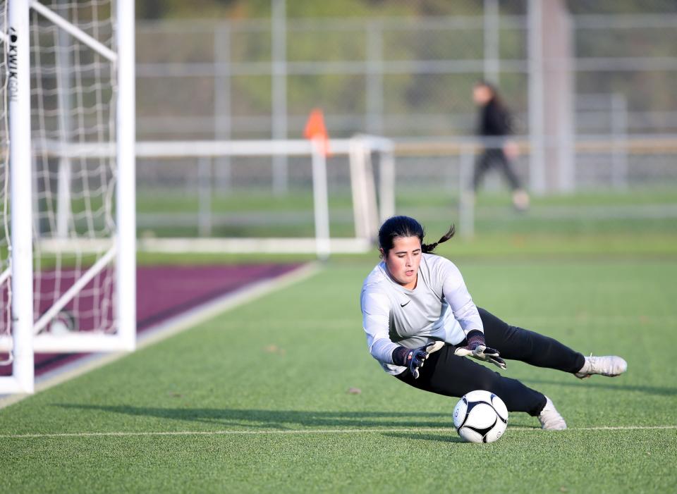 Ketcham's Emily Duro dives on a shot from an Arlington payer during Monday's game on October 16, 2023.