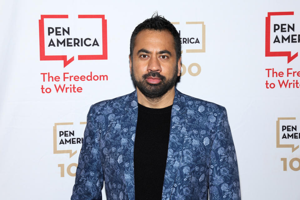 Kal Penn posing on a red carpet