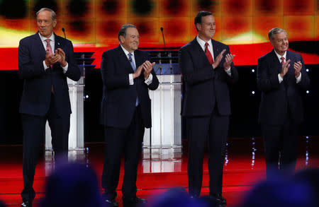 George Pataki, Mike Huckabee, Rick Santorum, and Lindsey Graham pose together before a forum for lower polling candidates. REUTERS/Mike Blake