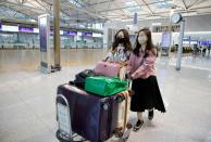 Kim Ji-eun and Lee Hyun-joo, BTS fans, walk at the Incheon International Airport