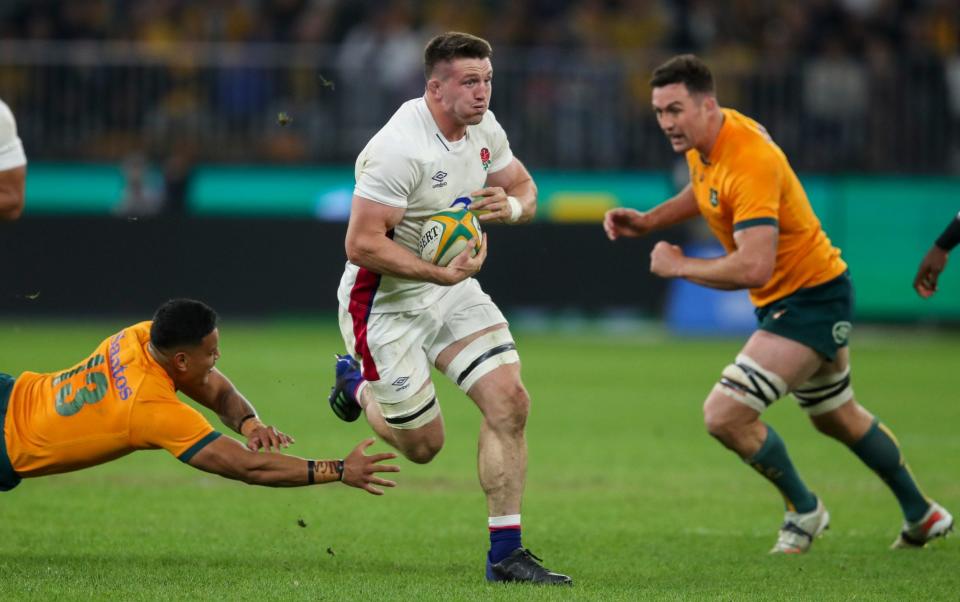 England's Tom Curry runs past the diving tackle of Australia's Len Ikitau, left, during the rugby international between England and the Wallabies in Perth, Australia, Saturday, July 2, 2022. - AP