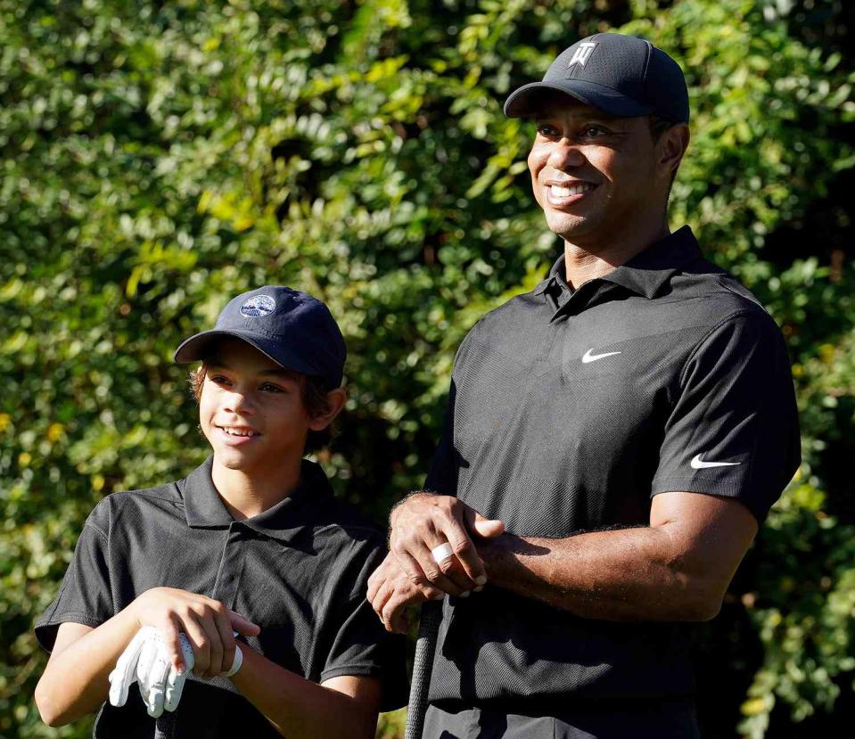 Tiger Woods and his son Charlie pose for photos, during the PNC Championship at the Ritz-Carlton Golf Club. Tiger Woods is making his return to competitive golf, 10 months after sustaining serious leg injuries in a car crash. Woods is paired with his son, Charlie for the tournament