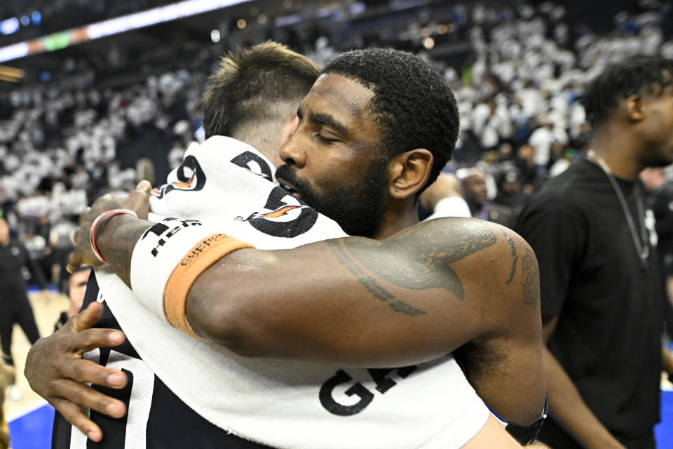 MINNEAPOLIS, MINNESOTA - MAY 22: Kyrie Irving #11 of the Dallas Mavericks hugs Luka Doncic #77 after defeating the Minnesota Timberwolves 108-105 in Game One of the Western Conference Finals at Target Center on May 22, 2024 in Minneapolis, Minnesota. NOTE TO USER: User expressly acknowledges and agrees that, by downloading and or using this photograph, User is consenting to the terms and conditions of the Getty Images License Agreement. (Photo by Stephen Maturen/Getty Images)