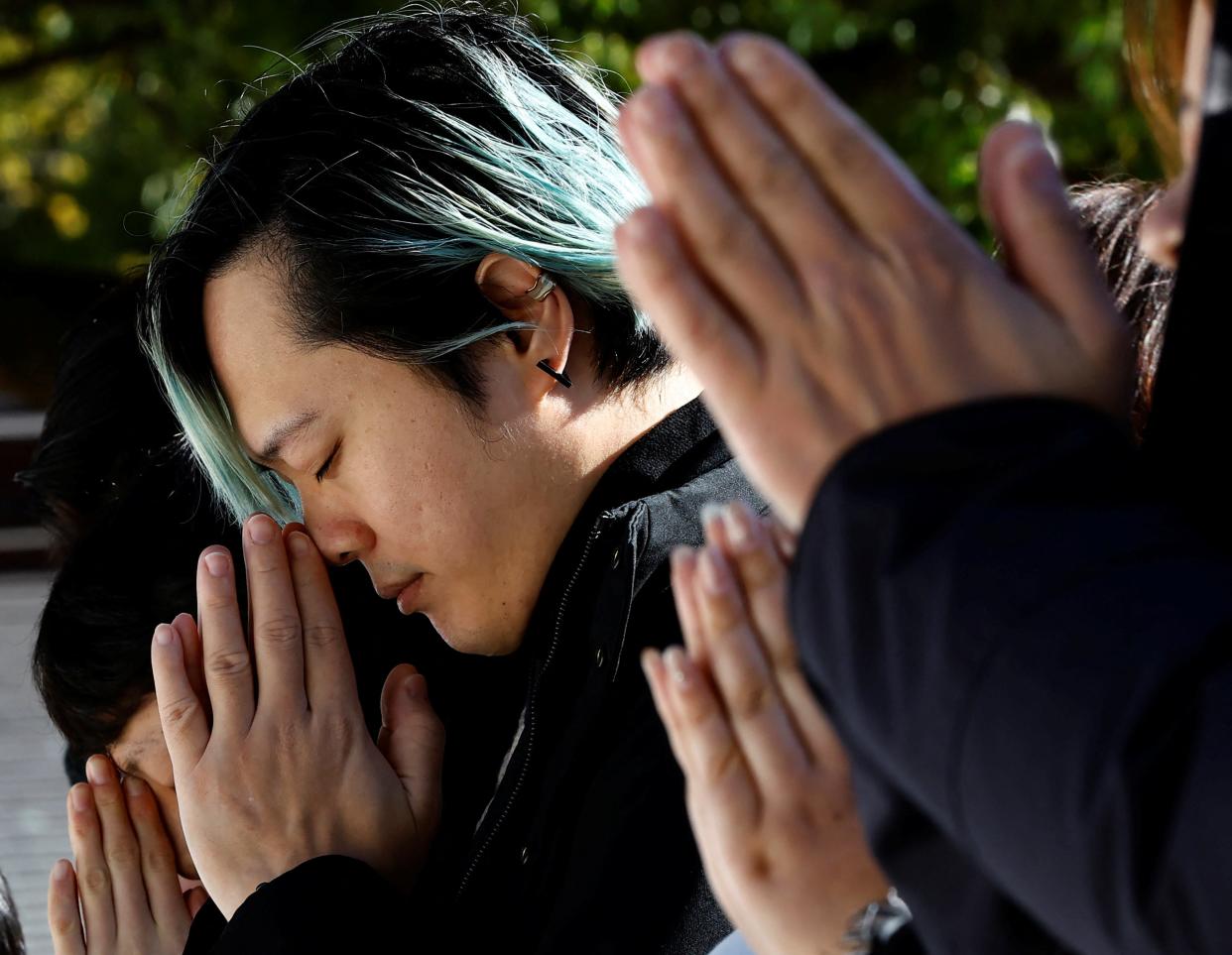 People pray on the first day of the new year at the Meiji Shrine in Tokyo, Japan 1 January 2024 (REUTERS)