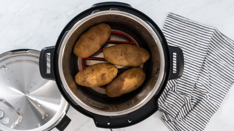 Baked potatoes in pressure cooker on counter
