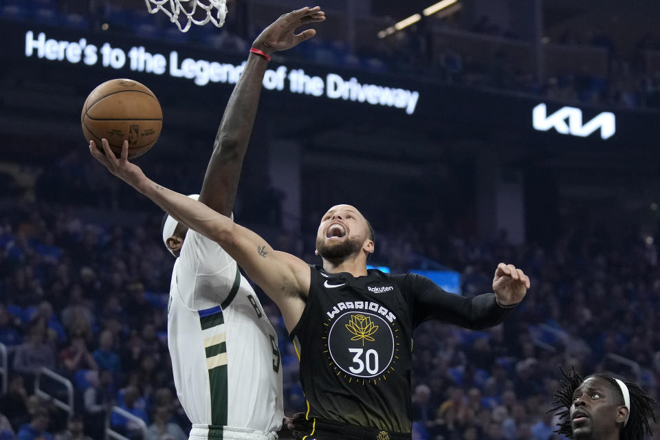 Golden State Warriors guard Stephen Curry (30) shoots against Milwaukee Bucks forward Bobby Portis during the first half of an NBA basketball game in San Francisco, Saturday, March 11, 2023. (AP Photo/Jeff Chiu)