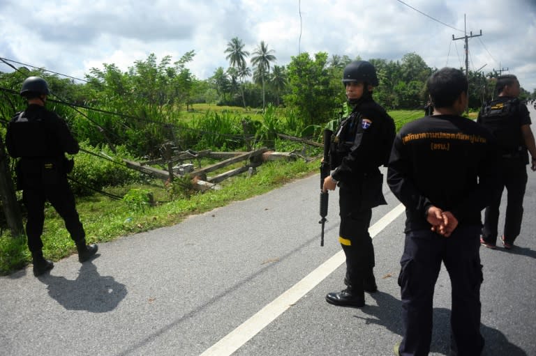 Thai Navy rangers examine a bomb site after insurgents damage dozens of electricity poles in the country's restive south