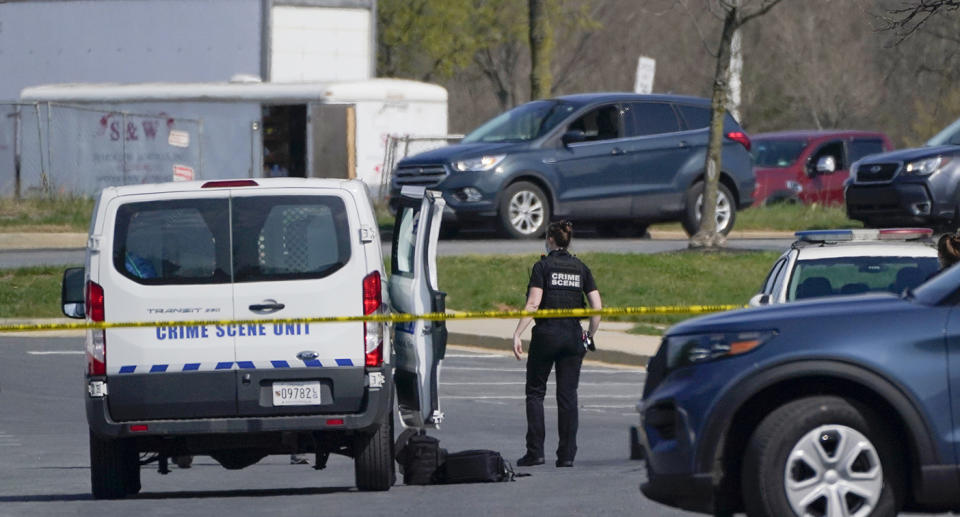 Police officer shown standing next to a police car at the scene of the rampage. Source: AP