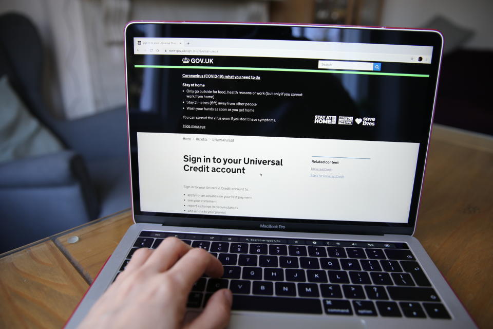 An information note displayed on the Government Gateway website advises people to stay at home during the Coronavirus (COVID-19) outbreak as a person visits the website to apply for Universal Credit online. Picture date: Friday March 27, 2020. Photo credit should read: Isabel Infantes/EMPICS Entertainment 