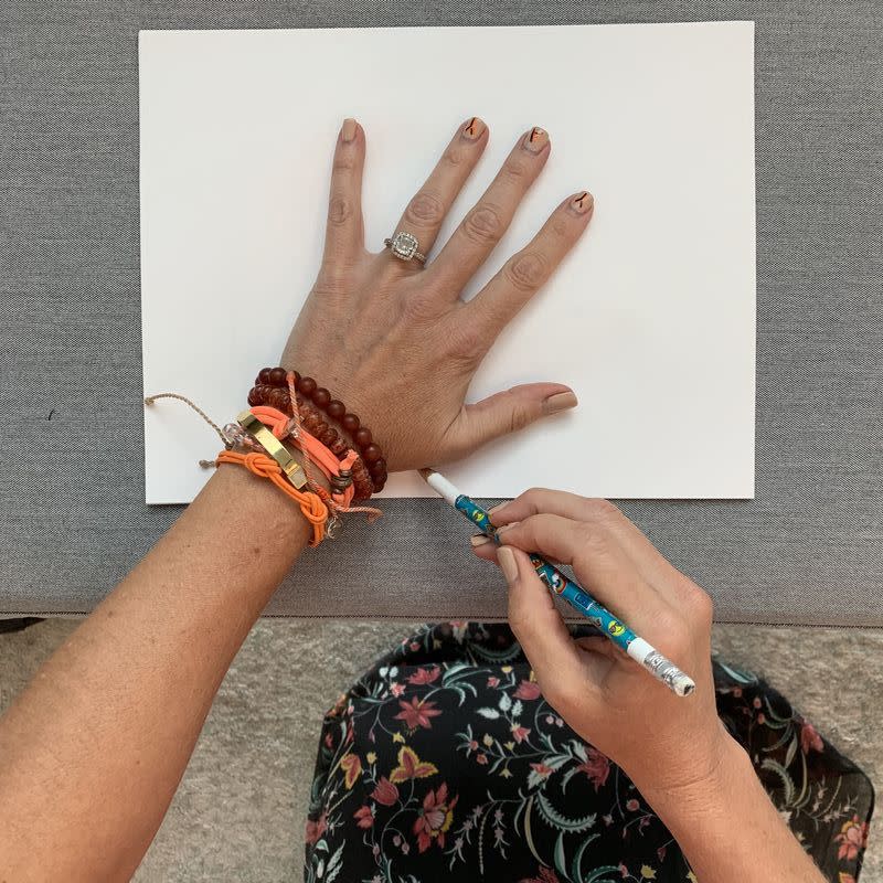 <p>Grab a fresh sheet of white computer paper and trace the outline of your hand using a sharp pencil. Tip: You might want to remove bracelets and bling for smoother lines ... unlike me!</p>