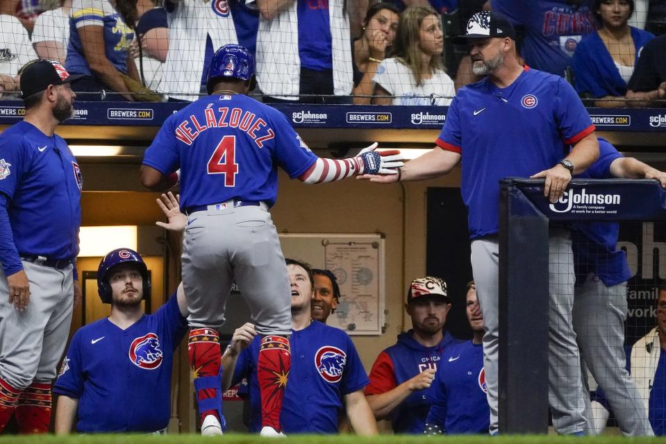 Chicago Cubs' Nelson Velazquez is congratulated after hitting a home run during the third inning of a baseball game against the Milwaukee Brewers Monday, July 4, 2022, in Milwaukee. (AP Photo/Morry Gash)