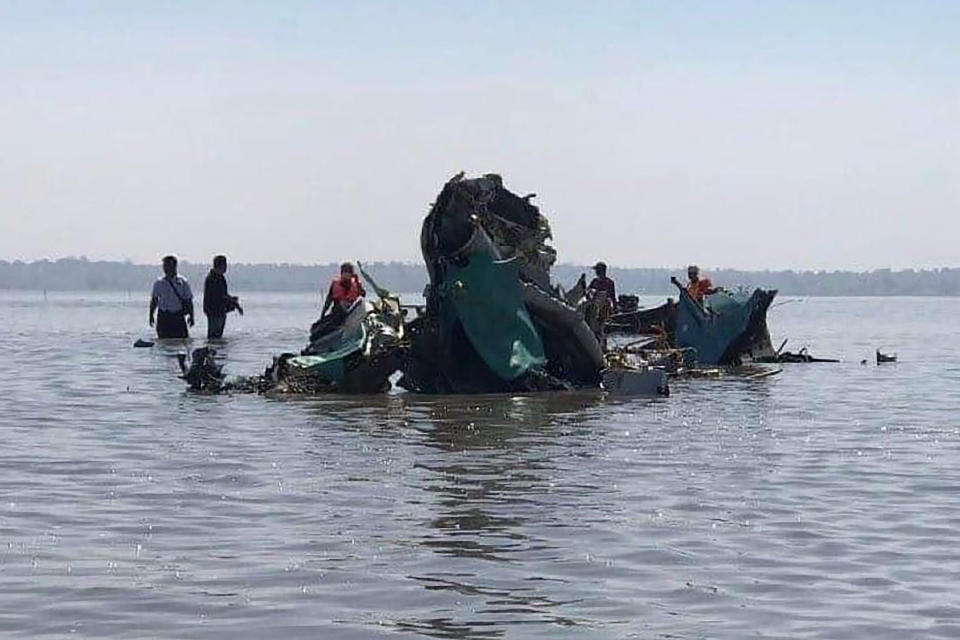 Recovery workers recover wreckage in a lake where a jet fighter crashed in the Sagaing region of Myanmar Wednesday, Feb. 16, 2022. The jet crashed into the lake Wednesday during a training flight in the country's northwest due to a malfunction, state-run media reported. (Khit Thit Media via AP)