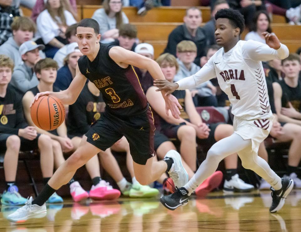 East Peoria's Cole DuBois (3) moves the ball against Peoria High's TJ Sturdivant in the second half of their boys basketball game Tuesday, Nov. 28, 2023 at Peoria High School.