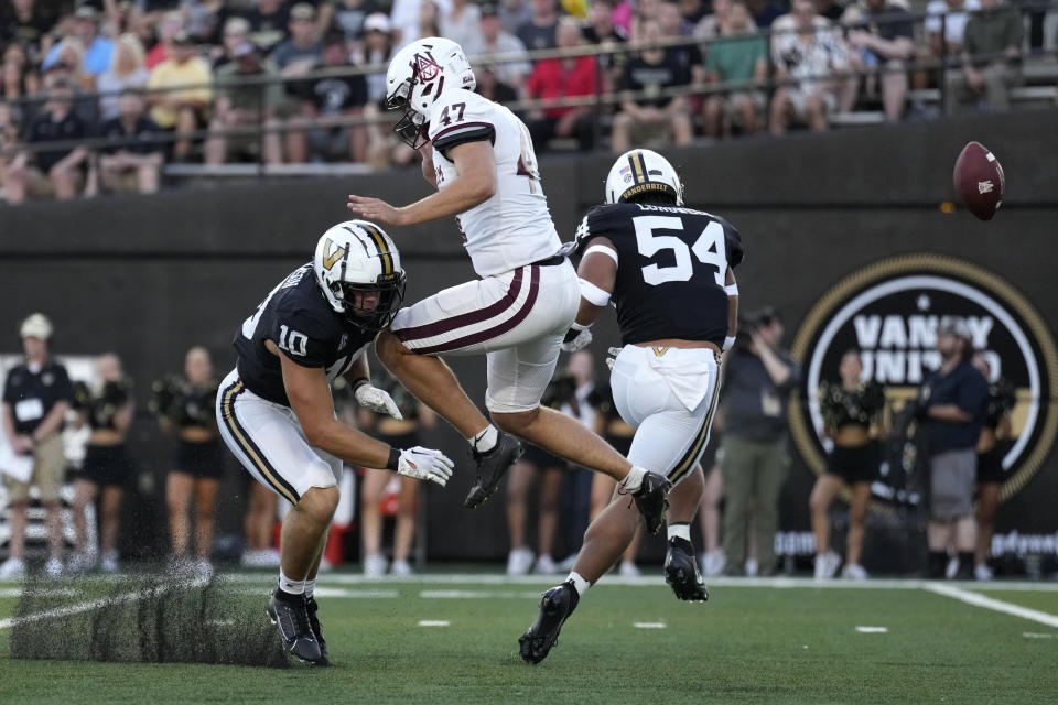 Vanderbilt linebacker Bryan Longwell (54) blocks a punt by Alabama A&M kicker Austin McCready (47) as Vanderbilt's Langston Patterson (10) also defends in the first half of an NCAA college football game Saturday, Sept. 2, 2023, in Nashville, Tenn. The ball went out of the end zone for a safety. (AP Photo/Mark Humphrey)