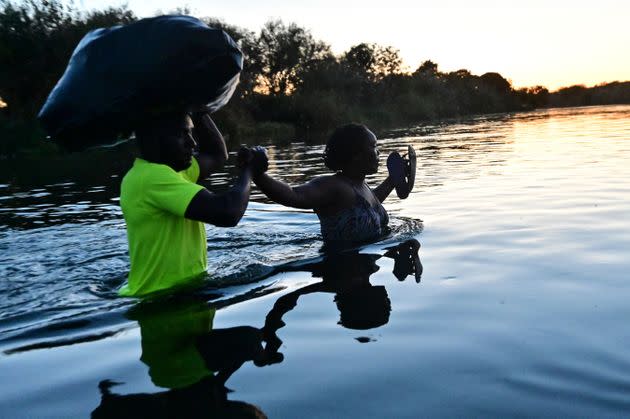 Haitian migrants cross the Rio Grande at the Mexico-U.S. border near Ciudad Acuna in Mexico — across the Rio Grande from Del Rio, Texas — on Thursday. (Photo: PEDRO PARDO via Getty Images)