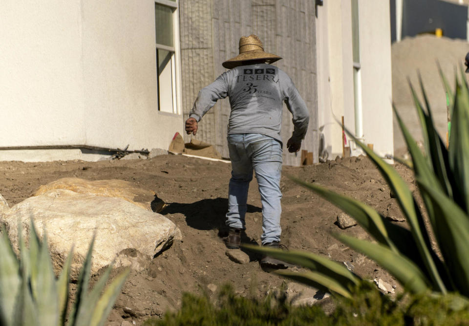 Image: A contractor works at an apartment complex in Palm Springs, Calif., on July 14. (Kyle Grillot / Bloomberg via Getty Images file)