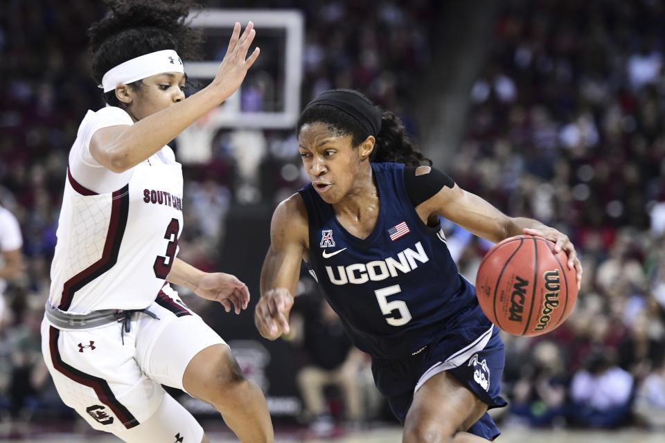 Connecticut guard Crystal Dangerfield (5) dribbles against South Carolina guard Destanni Henderson (3) during the second half of an NCAA college basketball game Monday, Feb. 10, 2020, in Columbia, S.C. South Carolina defeated Connecticut 70-52. (AP Photo/Sean Rayford)