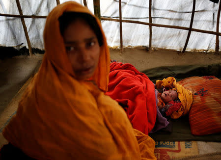 Noor Begum, 26, sits next to her one-day-old daughter Sumaiya as she poses for a photograph inside their shelter in Balukhali unregistered refugee camp in Cox’s Bazar, Bangladesh, February 8, 2017. REUTERS/Mohammad Ponir Hossain