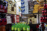 <p>A man stands in one of the main supermarkets in Langa, one of the poorest areas of Cape Town. Inside the store it’s only possible buy food and drinks high in sugar content. The origins of Globesity have often been associated with globalization and poverty, and caused by the spread of food and cheap drinks, rich in sugars and fats, which have radically changed the eating habits of people in many countries. That’s particularly true in the emerging markets of developing countries, where a high percentage of the population lives below the poverty line, without access to quality food and easy access to cheap junk food. (Photograph by Silvia Landi) </p>