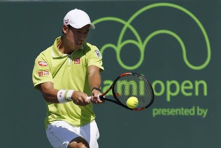 Kei Nishikori hits a backhand against Viktor Troicki (not pictured) on day eight of the Miami Open at Crandon Park Tennis Center. Nishikori won 6-2, 6-2. Mandatory Credit: Geoff Burke-USA TODAY Sports