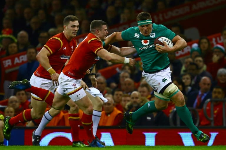 Ireland's flanker CJ Stander (R) tries to hand-off Wale's centre Scott Williams during their Six Nations rugby union match, at the Principality Stadium in Cardiff, south Wales, on March 10, 2017