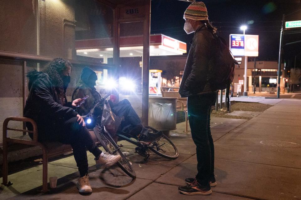 Nicky Stevens (left) and Kelli Williams (right, both with MAG) interview a homeless man during Maricopa County's annual Point-in-Time count, Jan. 25, 2022, near Seventh Avenue and Roosevelt Street in Phoenix.