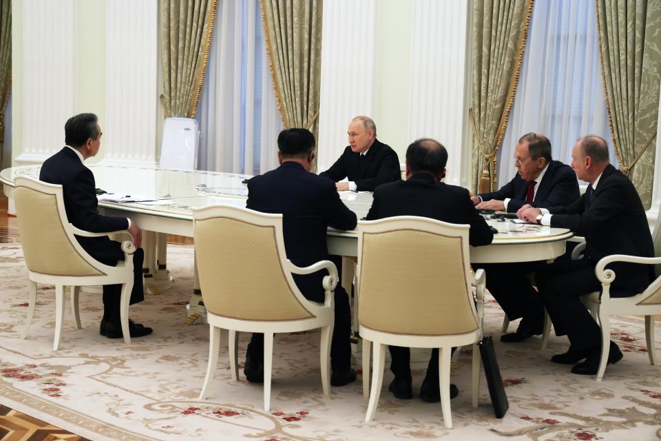 Russian President Vladimir Putin, center, and the Chinese Communist Party's foreign policy chief Wang Yi, left, attend the talks during their meeting at the Kremlin in Moscow, Russia, Wednesday, Feb. 22, 2023. (Anton Novoderezhkin, Sputnik, Kremlin Pool Photo via AP)