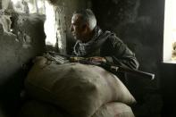 A member of the Kurdish police known as the Asayesh observes enemy positions from a lookout point in the northeastern Syrian city of Hasakeh during fighting with regime forces on August 22, 2016