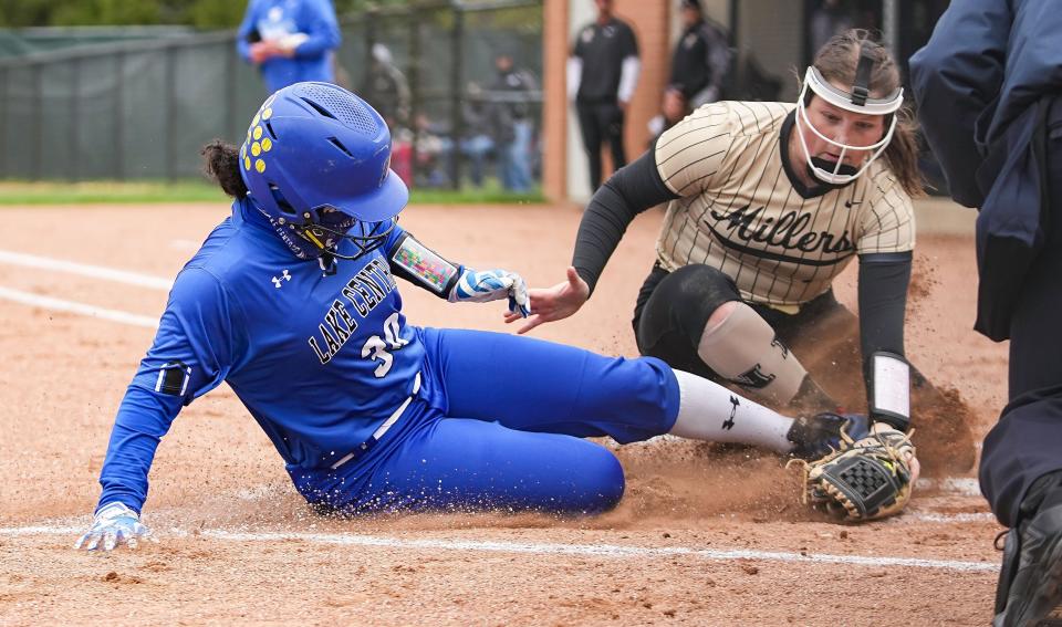 Lake Central's Jolie Adams slides into first base Saturday, April 22, 2023 at Cherry Tree Softball Complex in Carmel. 