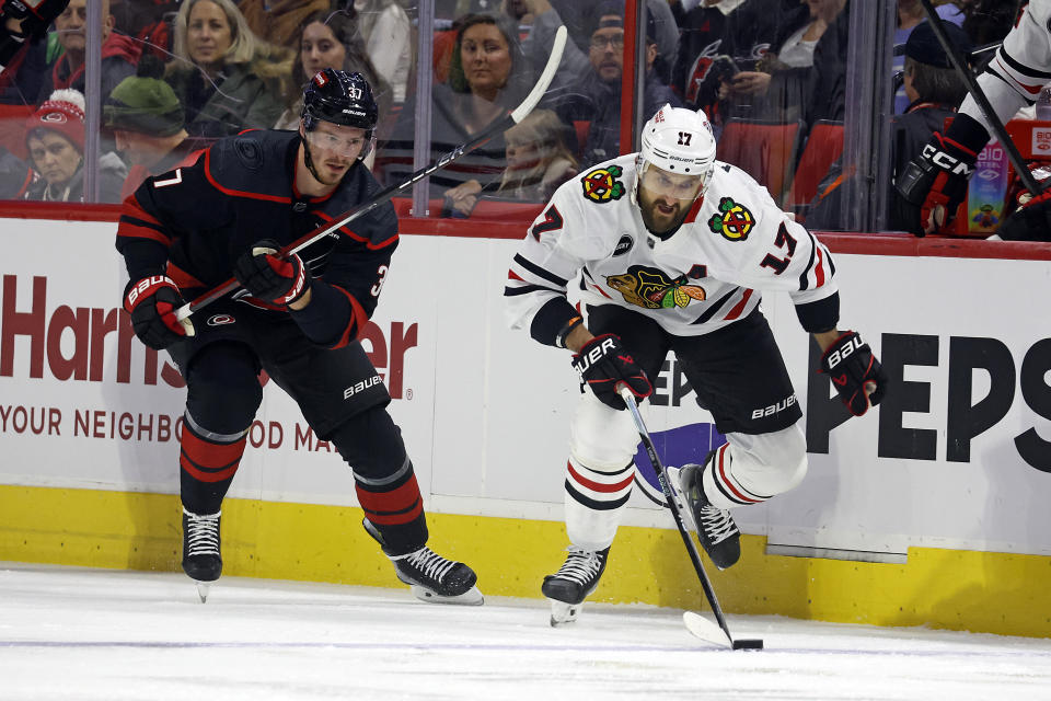 Chicago Blackhawks' Nick Foligno (17) moves the puck after taking it from Carolina Hurricanes' Andrei Svechnikov during the first period of an NHL hockey game in Raleigh, N.C., Monday, Feb. 19, 2024. (AP Photo/Karl B DeBlaker)