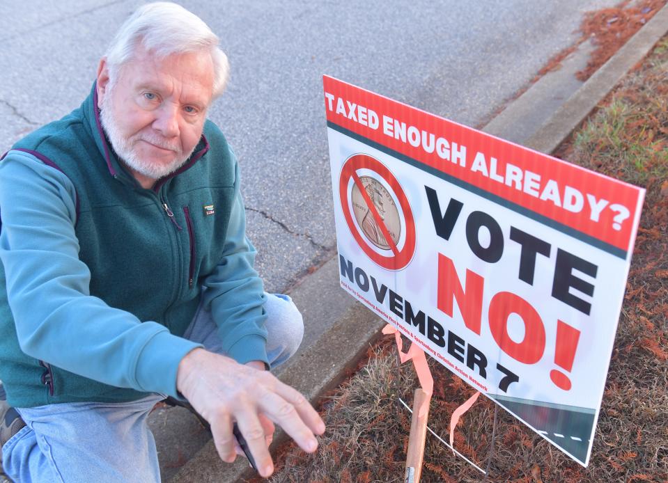 On Tuesday Nov. 7, 2023 in Spartanburg County voters will decide the penny sales tax and other municipal races in the area. Larry Bateman of Spartanburg puts up a 'Vote No Penny Tax' sign outside the polling place of Anderson Mill Elementary School.