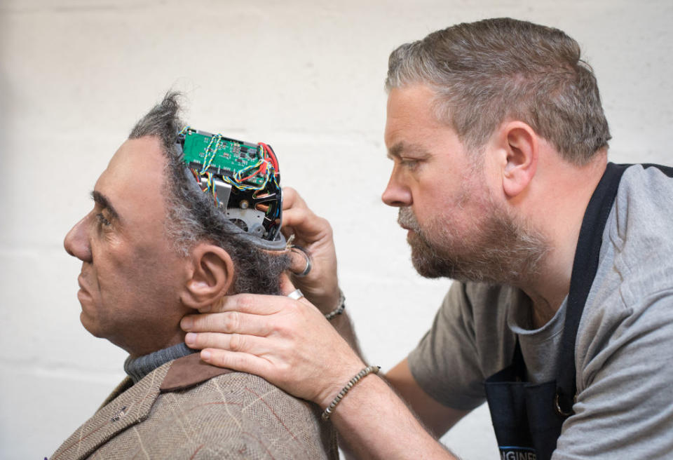 <p>Engineered Arts prosthetic expert Mike Humphrey checks on Fred, a recently completed Mesmer robot that was built at the company’s headquarters in Penryn on May 9, 2018 in Cornwall, England. Founded in 2004, the Cornish company operating from an industrial unit near Falmouth, is a world leader in life sized commercial available humanoid robots for entertainment, information, education and research. The company has successfully sold its the fully interactive and multilingual RoboThespian robot around the world to science centres, theme parks and visitor attractions, and also to academic and commercial research groups where they are used as research and development platforms. (Photo from Matt Cardy/Getty Images) </p>