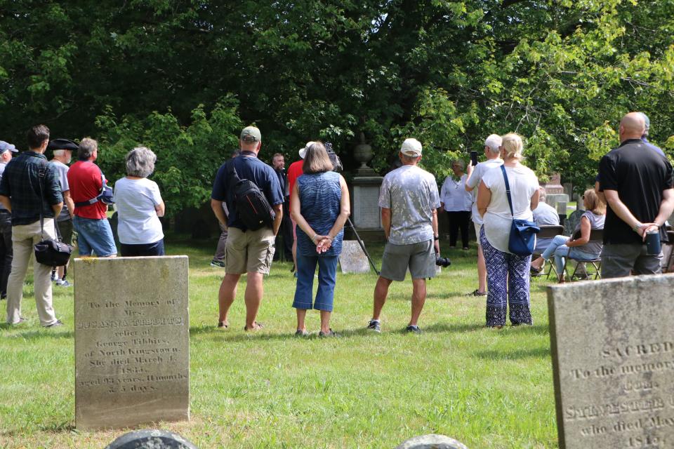 People gathered in Warren's North Burial Ground on Monday listen to details about Nicholas Cambell's participation in the Boston Tea Party in 1773.