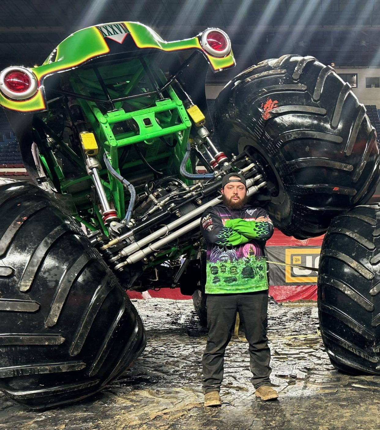 Jefferson graduate Chandler West stands in front of Grave Digger. West is the crew chief for the monster truck that will compete in the upcoming Monster Jam.