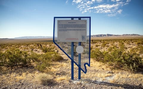 A historic landmark sign indicate that the area was the Nevada test site for nuclear weapons near the Area 51, near Amargosa Valley, Nevada - Credit: Rex