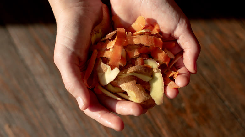 Hands holding vegetable peels