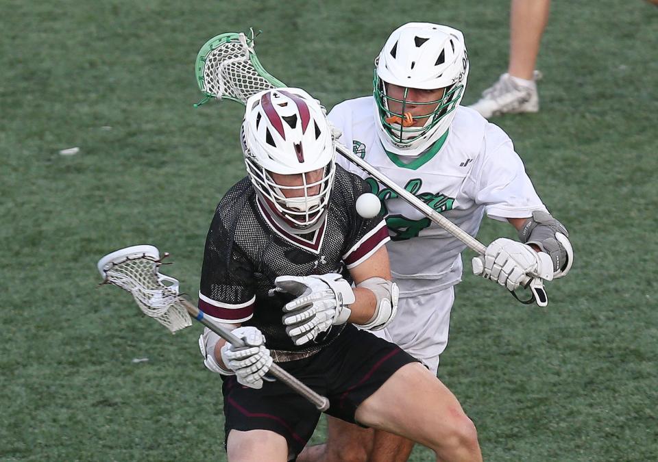 Scarsdale's Colby Baldwin (1) has the ball knocked away by Farmingdale's Dillon Mehta (99) during the boys lacrosse state Class A semifinal at Fallon Field on the campus of the University at Albany June 9, 2023. Farmingdale won the game 9-5.