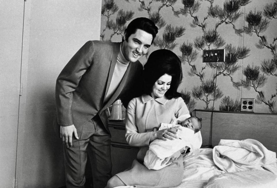 Lisa Marie Presley poses for her first picture, in the lap of her mother, Priscilla, on Feb. 5, 1968, with her father, Elvis Presley.