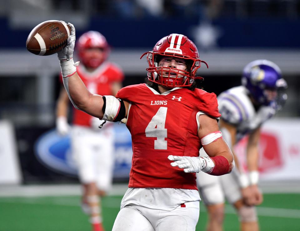 Albany running back Coy Lefevre holds he ball up after scoring a touchdown against Mart during the Class 2A Div. II state football championship last season at AT&T Stadium in Arlington.