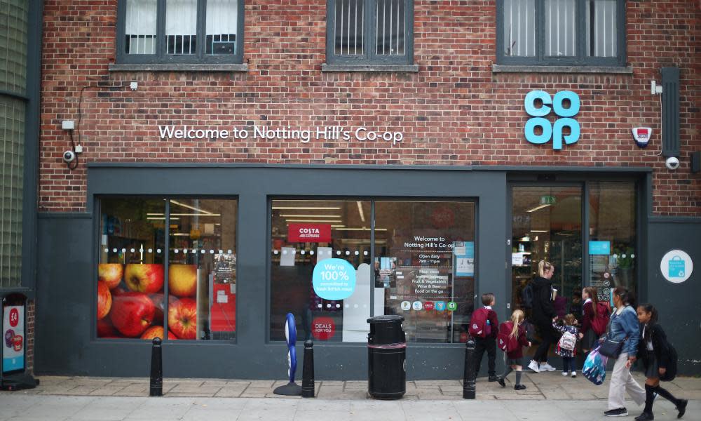 People walk past a Co-op supermarket in London.