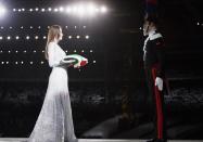 <p>Italian singer and supermodel Carla Bruni performed a song during the opening ceremony in her hometown of Turin. Dressed in a silver sequin ballgown, Bruni then delivered a folded Italian flag to be flown in the stadium. </p>