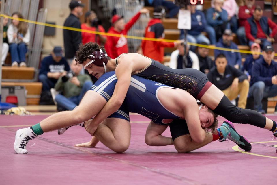 Arlington's Caleb Plunkett, top, wrestles Newburgh's William Coughlin during in the Mid-Hudson wrestling Tournament on Dec. 28, 2023.