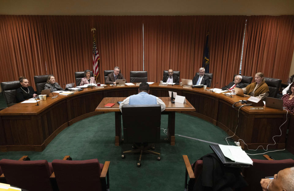 Nebraska state Sen. Justin Wayne, center, speaks on behalf of LB20, a bill he introduced to provide restoration of voting rights upon completion of a felony sentence or probation for a felony, during a hearing before the Government, Military and Veterans Affairs Committee on Wednesday, Feb. 22, 2023, at the Nebraska State Capitol in Lincoln, Neb. (AP Photo/Rebecca S. Gratz)