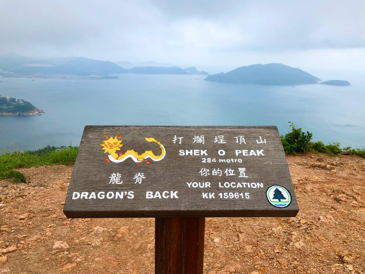 Hiking around the Dragon's Back trails in the hills of Shek O Country Park with panoramic landscape view