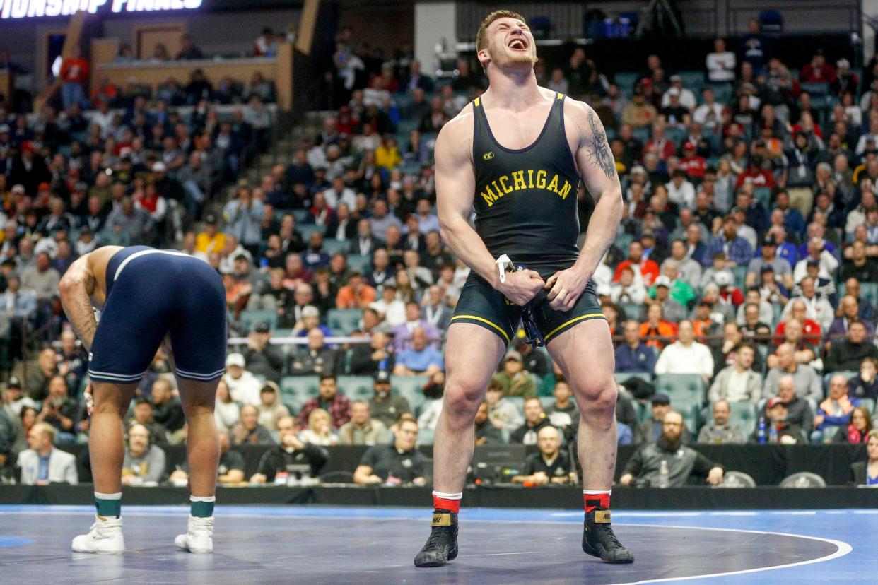 Michigan's Mason Parris celebrates after defeating Penn State's Greg Kerkvliet during the championship round of the NCAA Wrestling Championships 2023 at the BOK Center in Tulsa, Okla. on March 18, 2023. Parris  received the Dan Hodge Trophy as the nation's top collegiate wrestler.