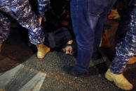 Riot police arrest a protester during an anti-government protest in Beirut, Lebanon, Wednesday, Dec. 4, 2019. Protesters have been holding demonstrations since Oct. 17 demanding an end to corruption and mismanagement by the political elite that has ruled the country for three decades. (AP Photo/Bilal Hussein)