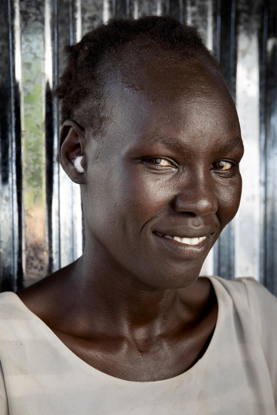 Belinda Idjidio, 36-years-old mother of 5, poses for a portrait at Paska Itwari Beda's Juba, South Sudan home, Saturday, May 29, 2021. With resources scarce, Beda and nine women formed a group that meets and contributes two of the barest necessities for warding off hunger and illness - money and bars of soap. They gather on Fridays, pooling supplies and handing them out to a different family every week. Over coffee, they share advice. (AP Photo/Adrienne Surprenant)