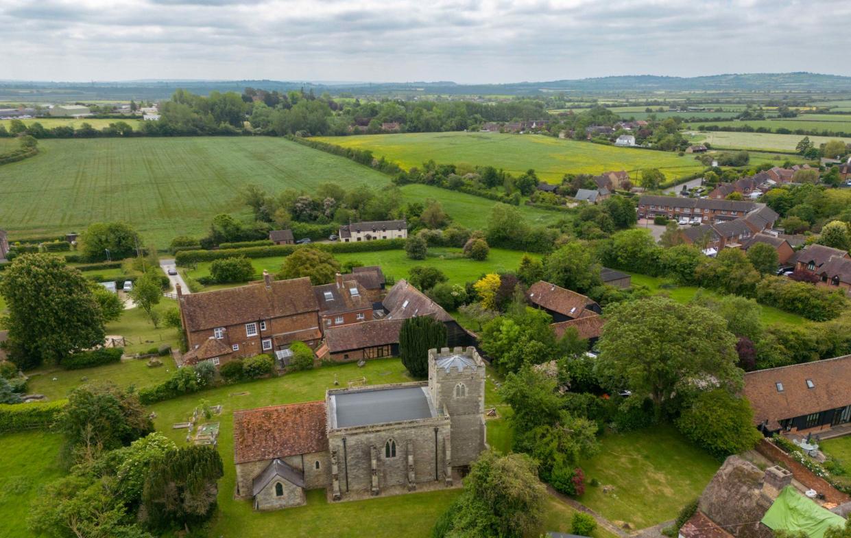 This picture shows the 12th century church of St Michael'€™s with the present prison sports hall visible to the left of the frame in the distance. The new facility would be visible above the tree line - Paul Grover for the Telegraph